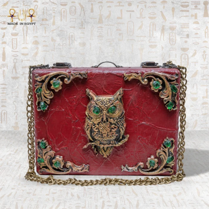 Handcrafted wooden “The Zodiac Sage” bag with ornate owl motif and green gemstone accents.