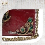 Floral metallic detail with green gemstones on The Zodiac Sage wooden shoulder bag.