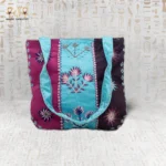 Handcrafted embroidered tote bag with vibrant flower motifs in purple, blue, and pink, showcasing Egyptian craftsmanship.