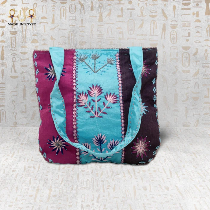Handcrafted embroidered tote bag with vibrant flower motifs in purple, blue, and pink, showcasing Egyptian craftsmanship.