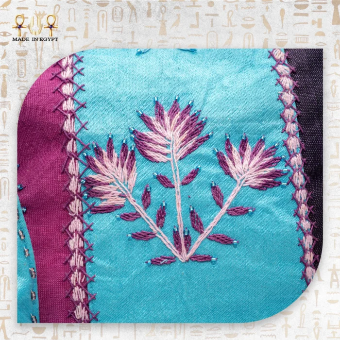 Close-up of intricate purple and pink floral embroidery on the "Threads Charm" tote bag, with delicate beadwork accents.