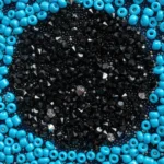 Turquoise Eye clutch with handcrafted blue, black, and silver bead embroidery forming a protective eye motif.