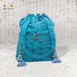 Turquoise Touch bag with floral embroidery design featuring purple and blue details, with tassel accents.