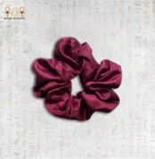 Velvet Rose satin scrunchie in deep burgundy color on neutral background.