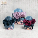 Set of three satin scrunchies including Velvet Rose Tie in burgundy, pink, and black displayed on branded cards.