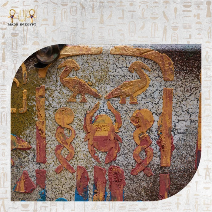 Close-up of ancient Egyptian hieroglyph carvings on Winged Scarab bag.