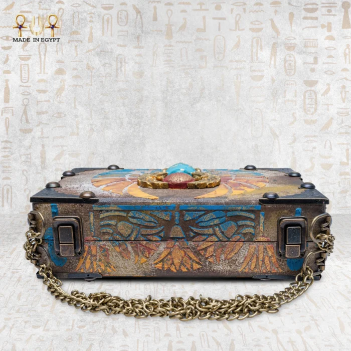 Flat view of Winged Scarab bag showing thickness and sculpted scarab centerpiece.