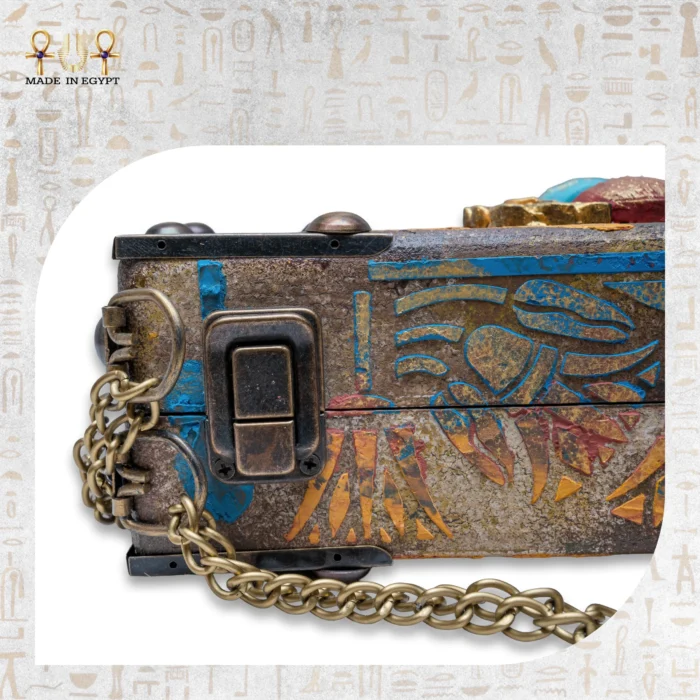 Detailed shot of brass lock and engraved textures on Winged Scarab bag.