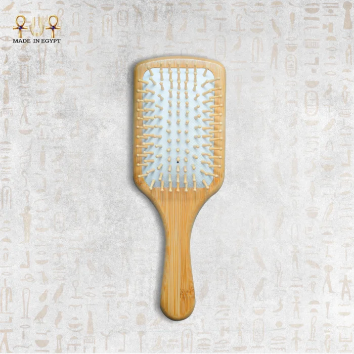 Wooden paddle hair brush with natural bristles on neutral background.
