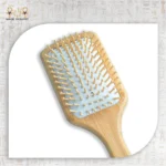 Close-up of wooden paddle brush bristles on white background.