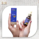 Argan Essential Oil, 30ml, bottle held with packaging box visible.