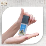 Hand holding CairoCharm Face Serum, ready for application.