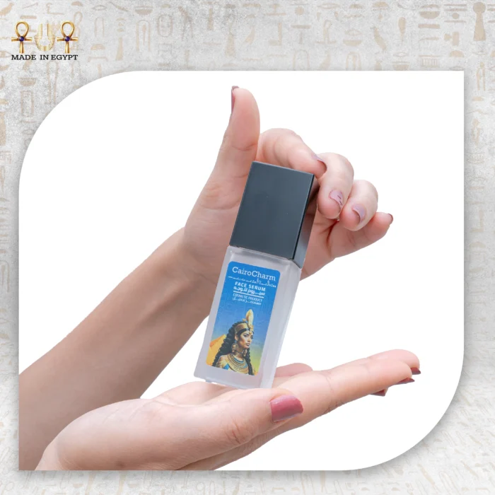 Hand holding CairoCharm Face Serum, ready for application.