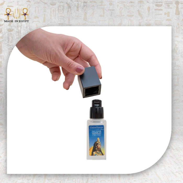 Hand holding the cap of CairoCharm Face Serum, a cosmetic product with natural oils.