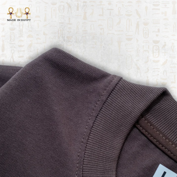 Close-up of the Fusion Tee fabric, showcasing the texture and weave of the brown cotton material.