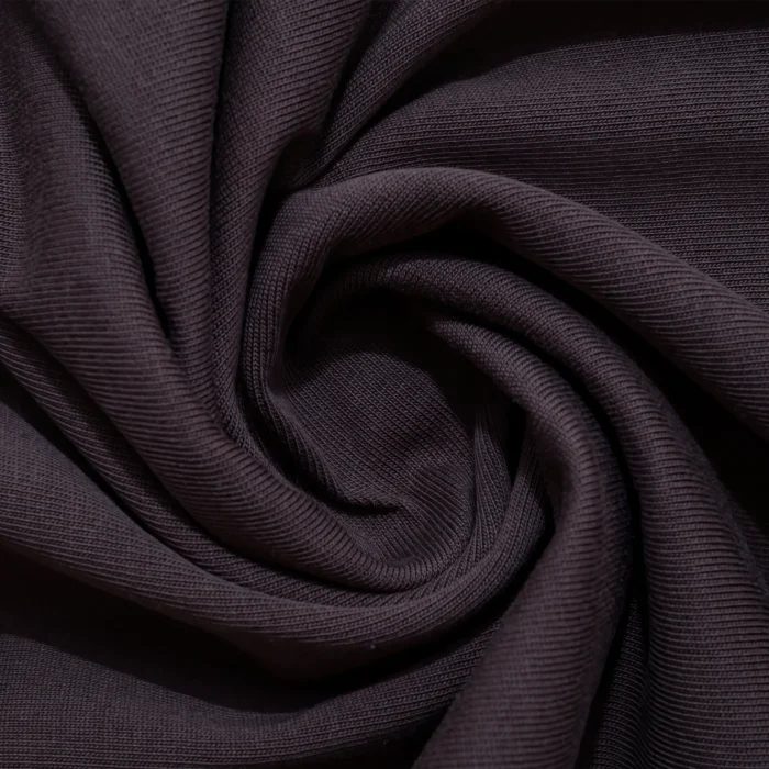 Close-up of the Fusion Tee fabric, showcasing the texture and weave of the brown cotton material.