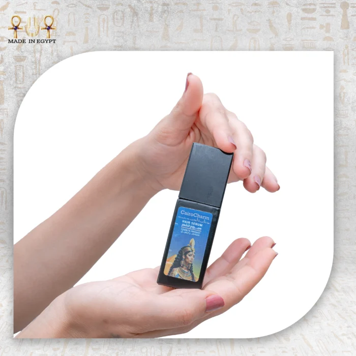 CairoCharm Hair Serum 30ml held in hand, with packaging box visible.