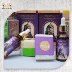 Assorted Queen Tiye products, including Chili Oil, Tea Tree Oil, Castor Oil, Ginger Oil, and CairoCharm Body Oil with soaps.