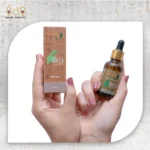 Rocca Essential Oil 100% Pure, 30 ml, with packaging, held in hand.