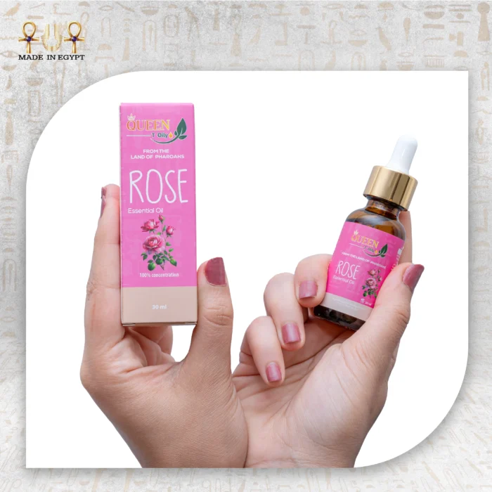 Rose Essential Oil 30ml bottle with pink packaging, held in hand. 100% concentration, from the Land of Pharaohs.