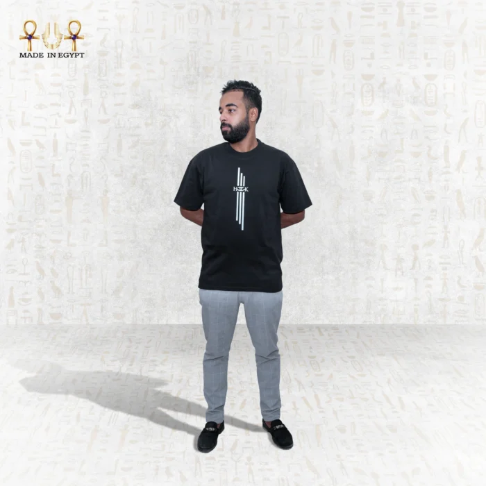 The Skyline Tee in black showcases a striking vertical white graphic on the front, adding a modern touch to its classic design. Made from premium cotton, it offers comfort, breathability, and a stylish fit for everyday wear.