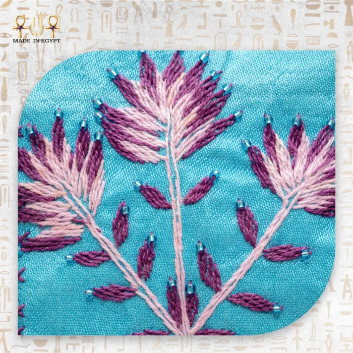 Detailed view of the floral embroidery on the "Threads Charm" tote, showcasing fine threads in pink, purple, and blue.